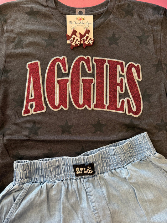 ARCHED AGGIES SMOKE STARS GAME DAY CHARCOAL BLACK TEE - MAROON/SILVER GLITTER PUFF