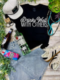 DRINKS WELL WITH OTHERS TEE - BLACK
